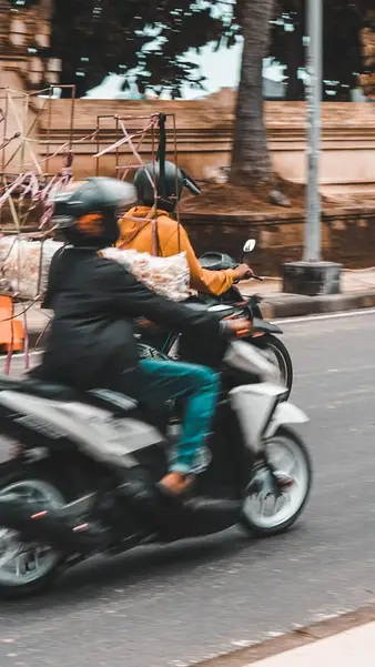 A rider with cargo on the coast road
