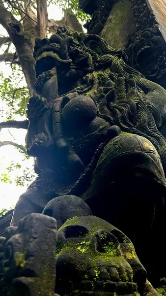 A moss-covered stone face in the temple grounds