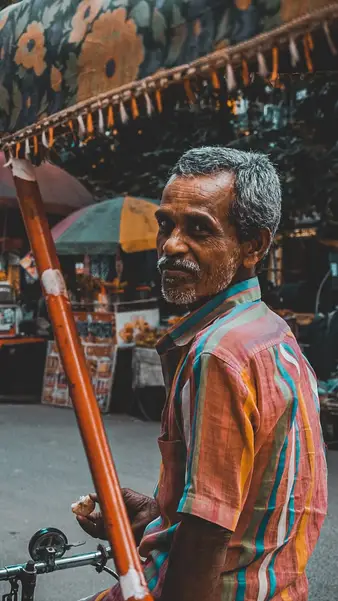 A vendor pausing behind his cart