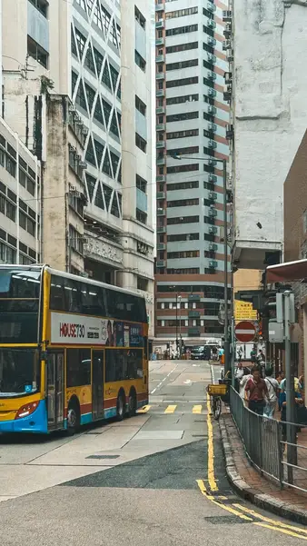 A bus turning below the towers