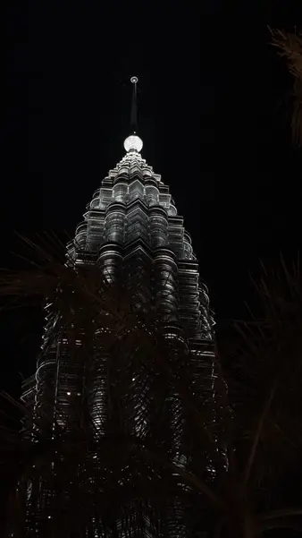 The crown of a Petronas tower at night