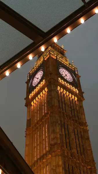 The same clock tower after dark, from under the arcade lights