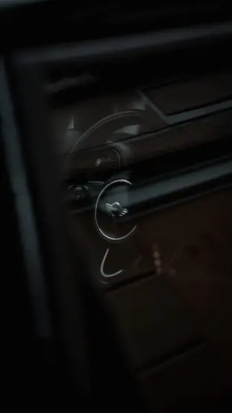 A door handle in the dark of a car