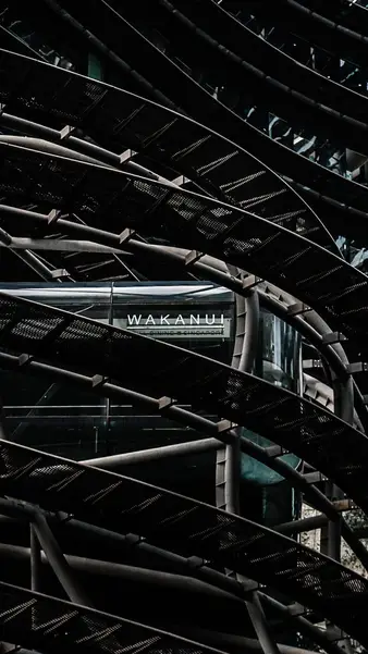 A steel lattice over a walkway, from below